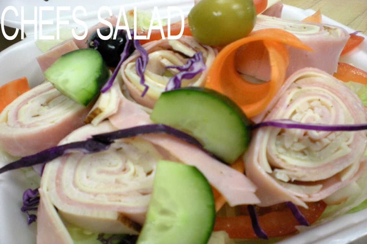 Chefs salad with rolled deli meats cucumbers and olives