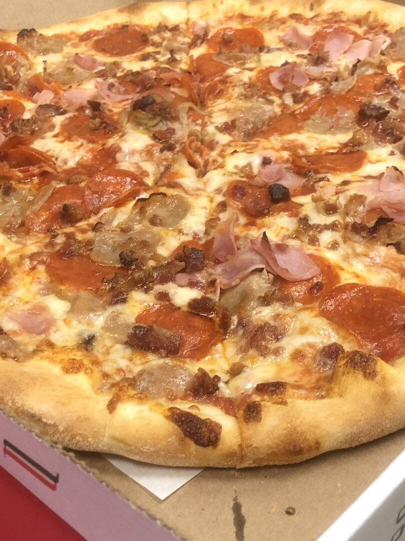 Meat lovers pizza with pepperoni bacon ham and sausage at Schianos Las Vegas Pizza