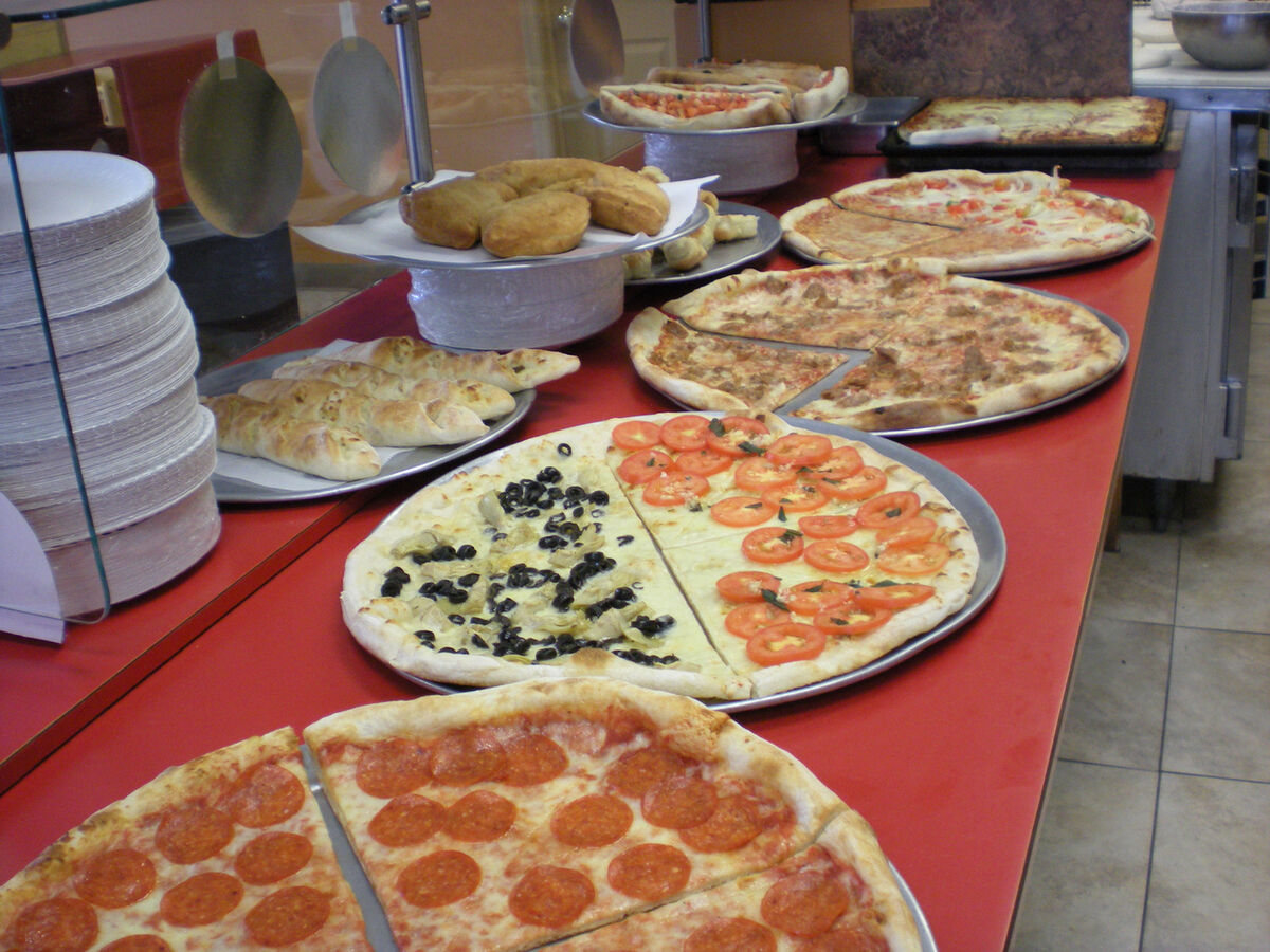 NYC-style pizzas and stromboli displayed fresh at Las Vegas Pizza counter in West Chester PA