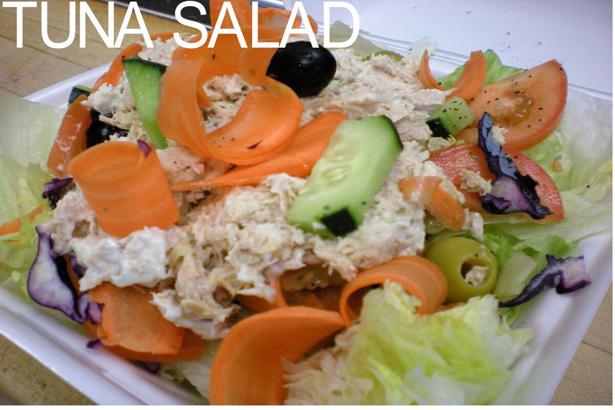 Fresh tuna salad with cucumbers carrots tomatoes and olives
